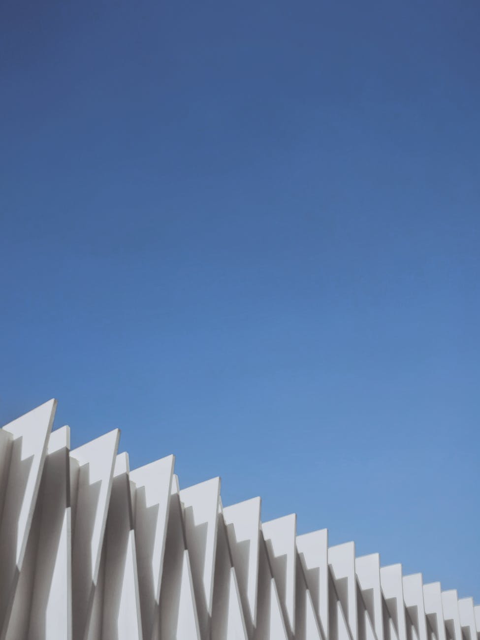 Abstract view of modern architectural design against a blue sky.
