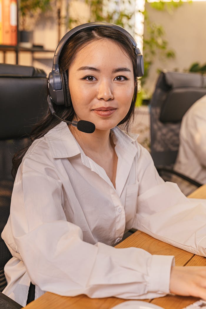 cta-bg Businesswoman with headset working at desk in modern office.